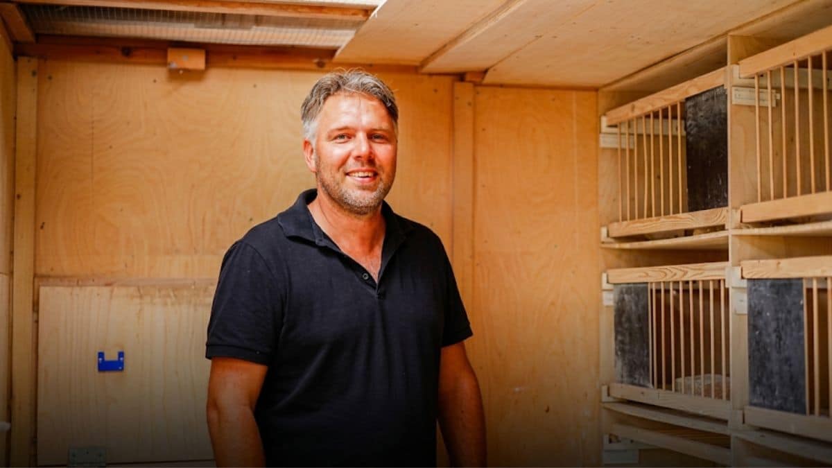 Irving van Oss of van Oss Pigeons smiling inside his breeding and racing loft in Den Bosch