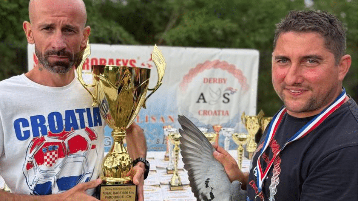 Two men celebrate the Derby AS Croatia Final 2026 with a winner’s trophy and racing pigeon after the 550 kilometre final.